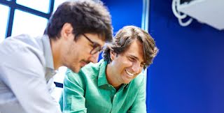 Two men are smiling