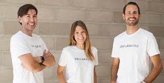 Founding team members of Declarando are posing against a wall with matching shirts.